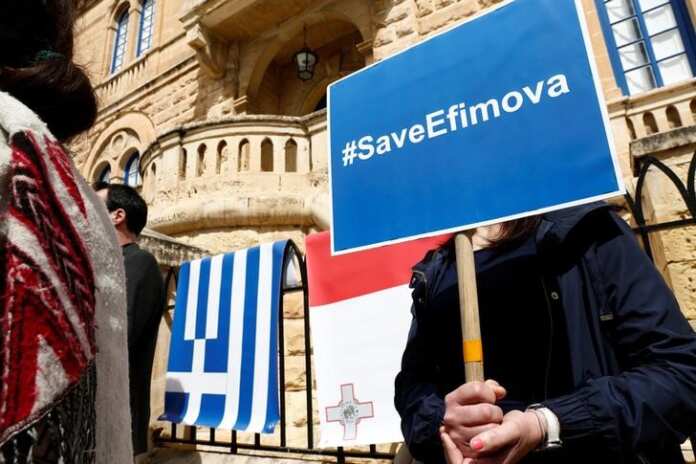 Civil society activists demonstrate outside the Greek Embassy, calling on the Greek government to grant political asylum to Maria Efimova, in Ta' Xbiex save efimova poster