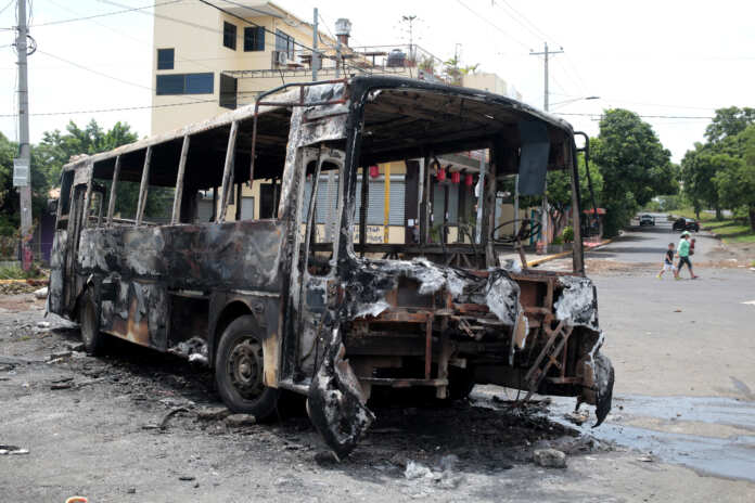 A burned bus is seen during a protest against Nicaragua's President Daniel Ortega's government at neighborhood in Managua