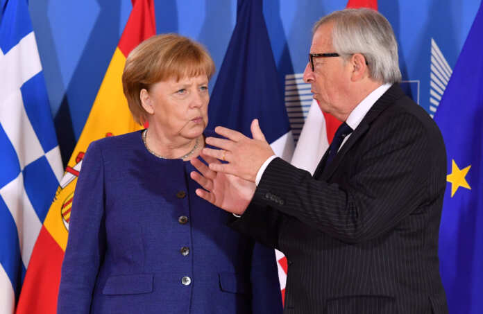 European Commission President Jean-Claude Juncker speaks with German Chancellor Angela Merkel during an informal EU summit on migration at EU headquarters in Brussels Jean-Claude Juncker speaks with Angela Merkel