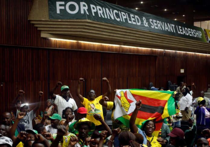 Supporters of President Emmerson Mnangagwa's ruling ZANU-PF party react to the results of a constitutional court hearing challenging his electoral victory in Harare