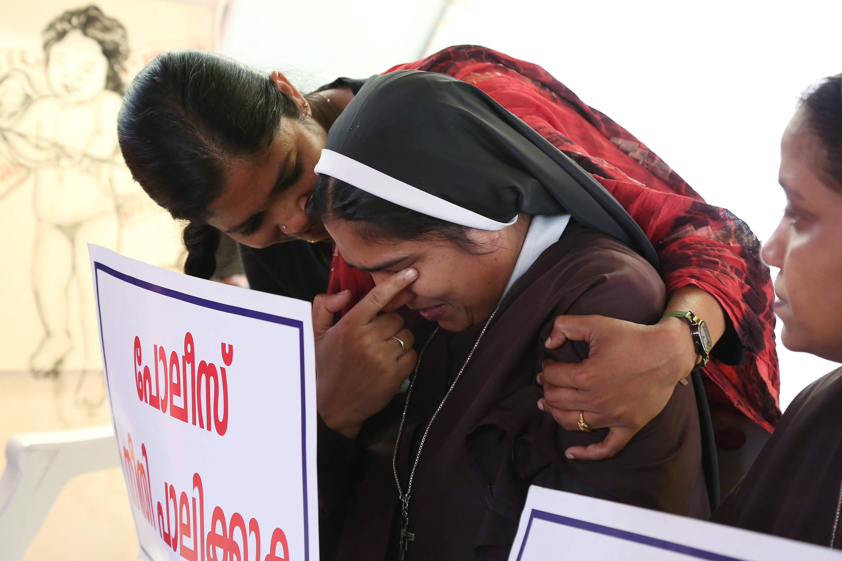 A woman consoles a nun during a protest demanding justice after an alleged sexual assault of a nun by a bishop in Kochi