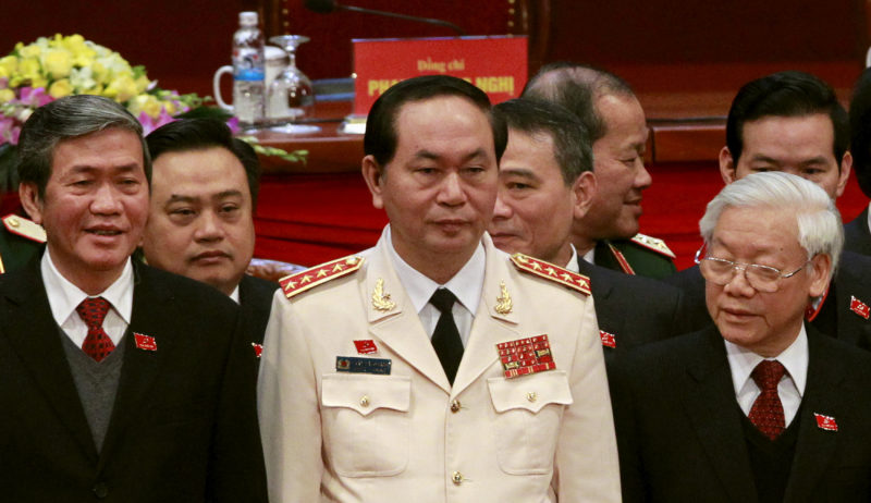 FILE PHOTO: Vietnam's Public Security (Police) Minister Quang stands with Communist Party Chief Trong and Politburo member Huynh at a closing ceremony of 12th National Congress of the Party in Hanoi