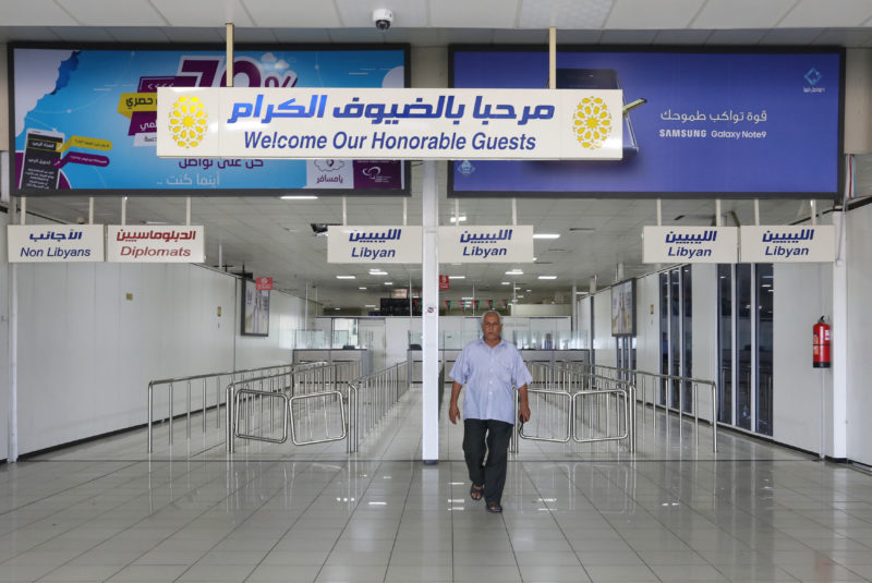 FILE PHOTO: A man walks inside the empty Mitiga airport, in Tripoli