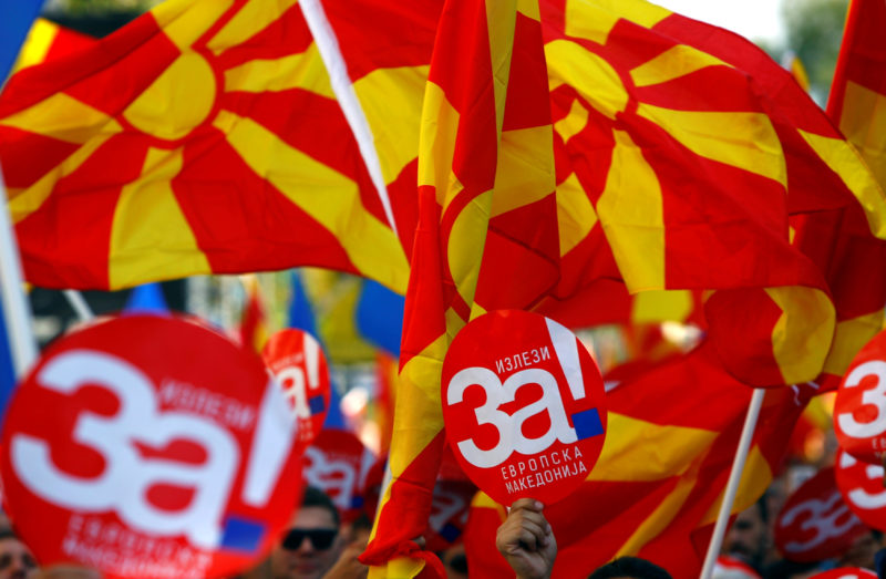 FILE PHOTO: People hold placards reading Yes for European Macedonia during a march in support of a referendum in Skpoje