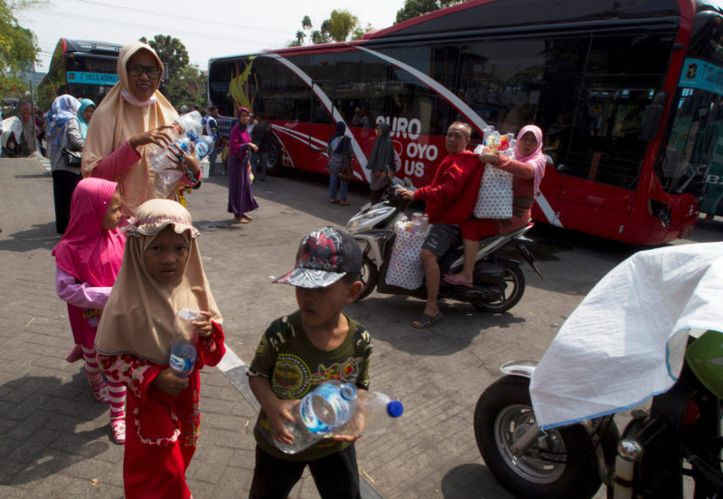 Residents bring plastic bottles to exchange for Suroboyo bus tickets at Purbaya station in Surabaya