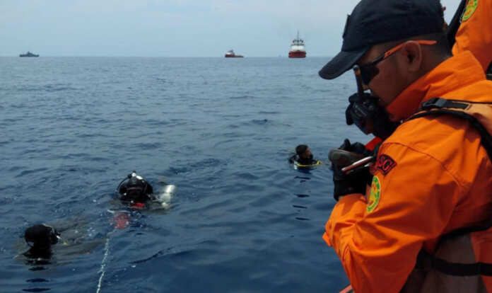 Rescue personnel prepare to dive at the location where a Lion Air plane crashed into the sea in the north coast of Karawang regency
