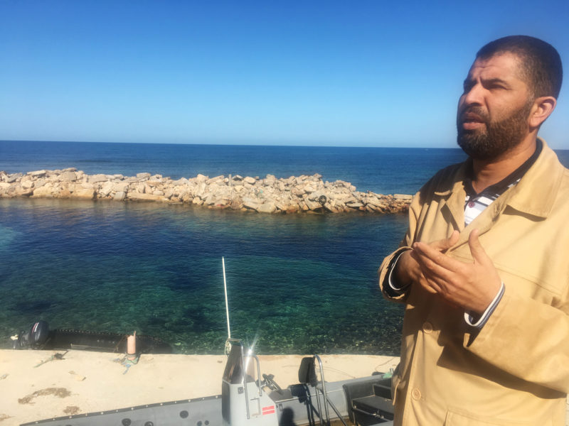 Coastguard official Ayman al-Dabbashi is seen on the seafront at the Libyan city of Sabratha