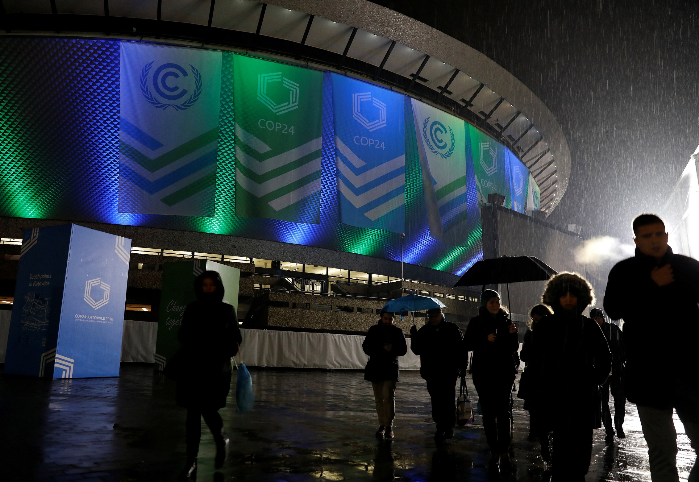 People walk in front of the venue of the COP24 U.N. Climate Change Conference 2018 in Katowice