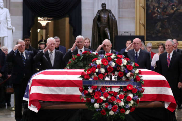 U.S. former Secretary of State Powell leads retired military leaders in a salute as the body of former U.S. President Bush lies in state in the Rotunda at the U.S. Capitol in Washington
