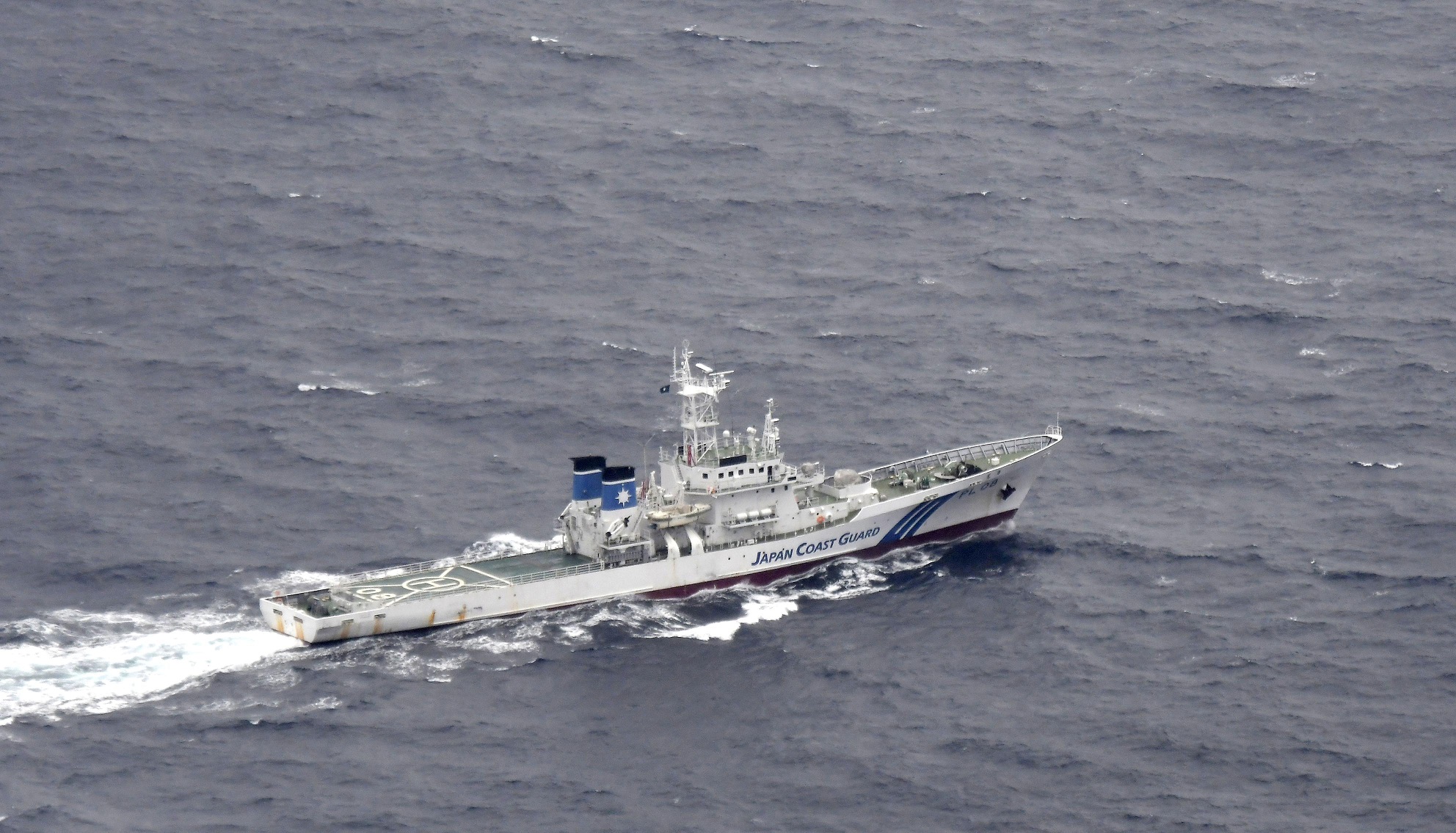 A Japan Coast Guard patrol vessel sails on the water at the area where two U.S. Marine Corps aircraft have been involved in a mishap in the skies, off the coast of Kochi prefecture, Japan