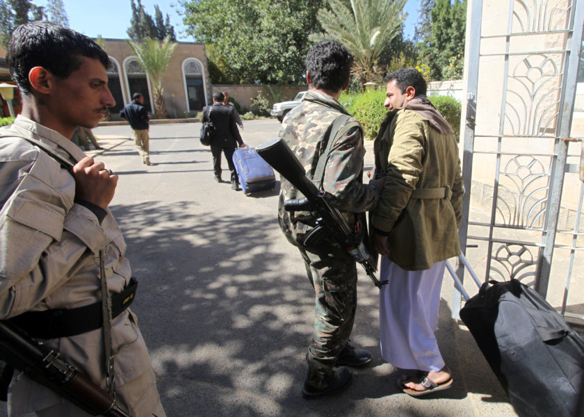 FILE PHOTO: A relative of a Houthi delegation member participating in the negotiations in Sweden carries a bag at Sanaa airport