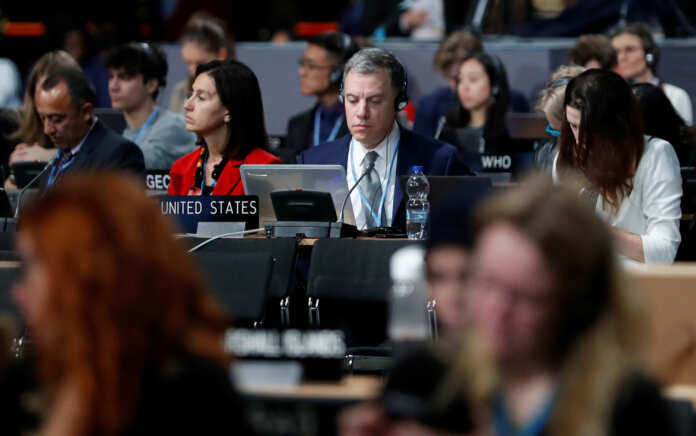 FILE PHOTO - Participants take part in plenary session, during the final day of the COP24 U.N. Climate Change Conference 2018 in Katowice