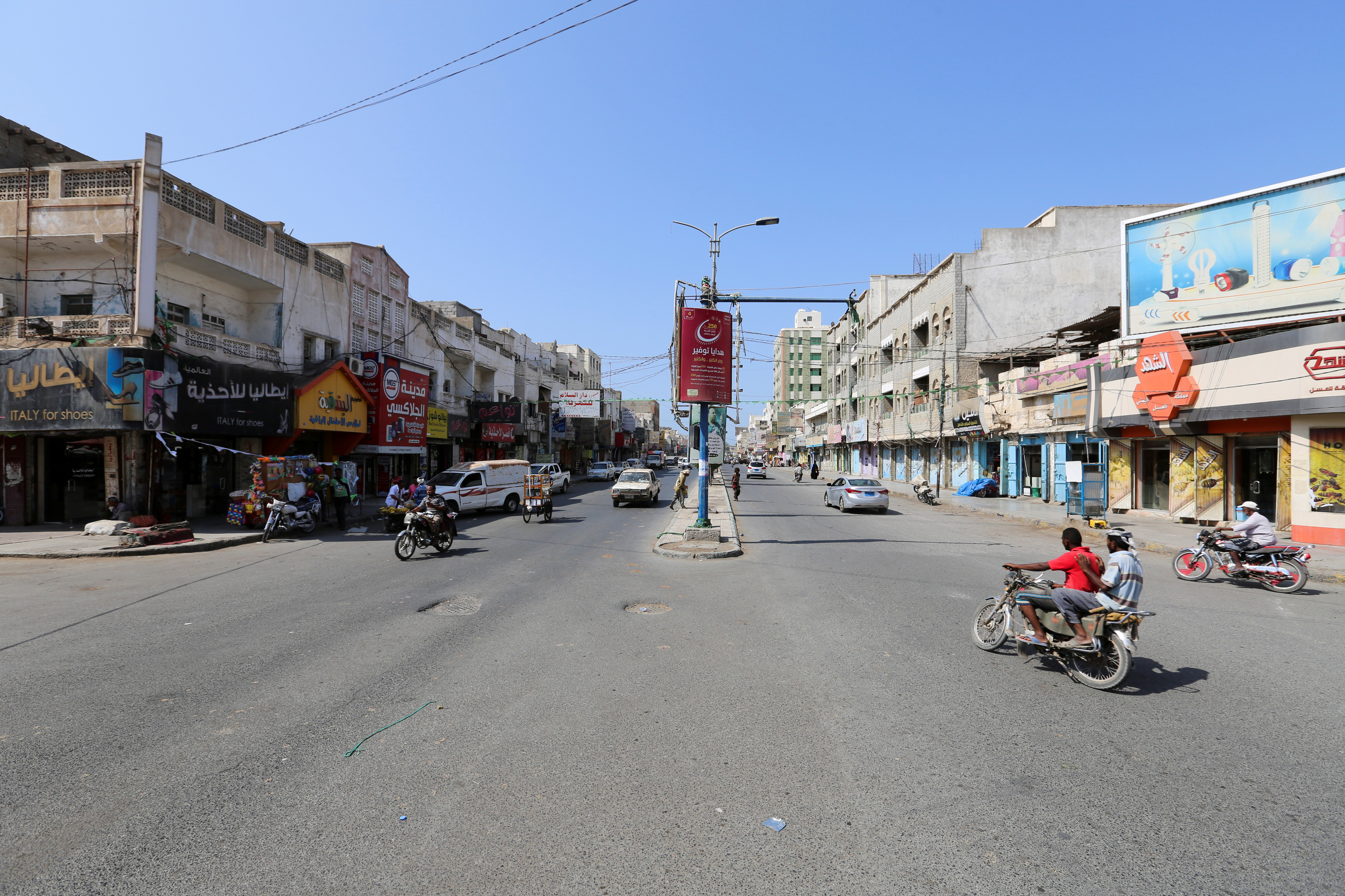 FILE PHOTO - People ride a motorbike on a street in Hodeidah