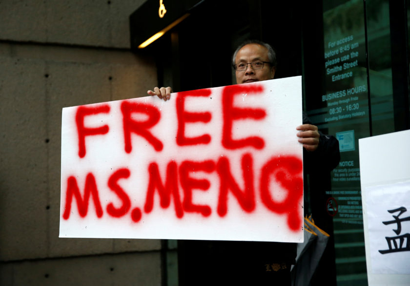 FILE PHOTO: Long holds a sign outside the B.C. Supreme Court bail hearing of Huawei CFO Meng Wanzhou