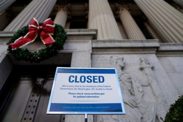 A sign declares the National Archive is closed due to a partial federal government shutdown in Washington