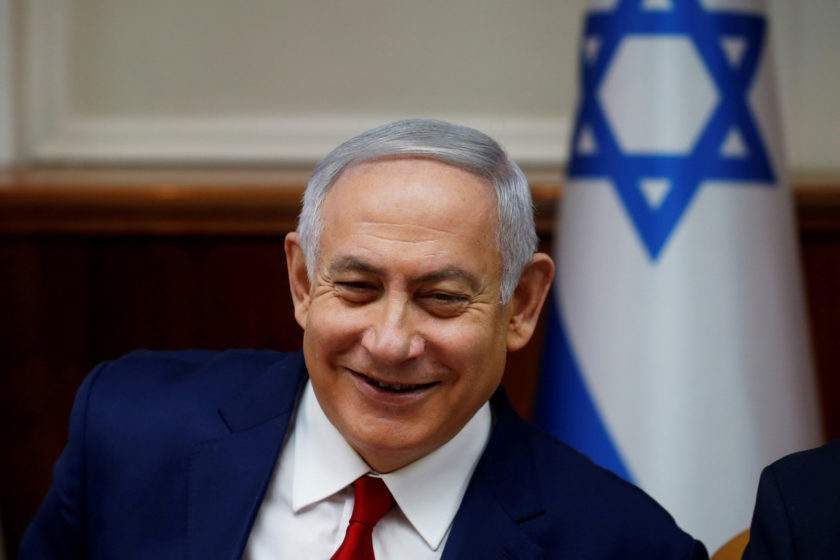 FILE PHOTO: Israeli Prime Minister Benjamin Netanyahu smiles during the weekly cabinet meeting in Jerusalem