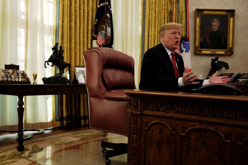 FILE PHOTO: U.S. President Donald Trump speaks with reporters after holding a video call with U.S. military service members in the Oval Office on Christmas morning in Washington