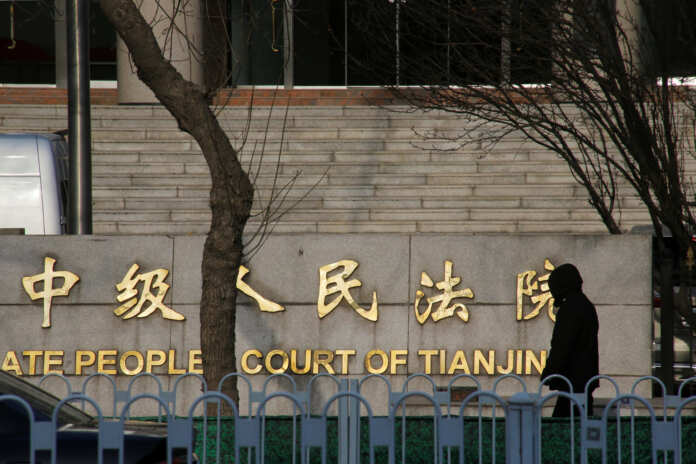 Man walks outside an Intermediate People's Court where prominent rights lawyer Wang Quanzhang is being tried, in Tianjin