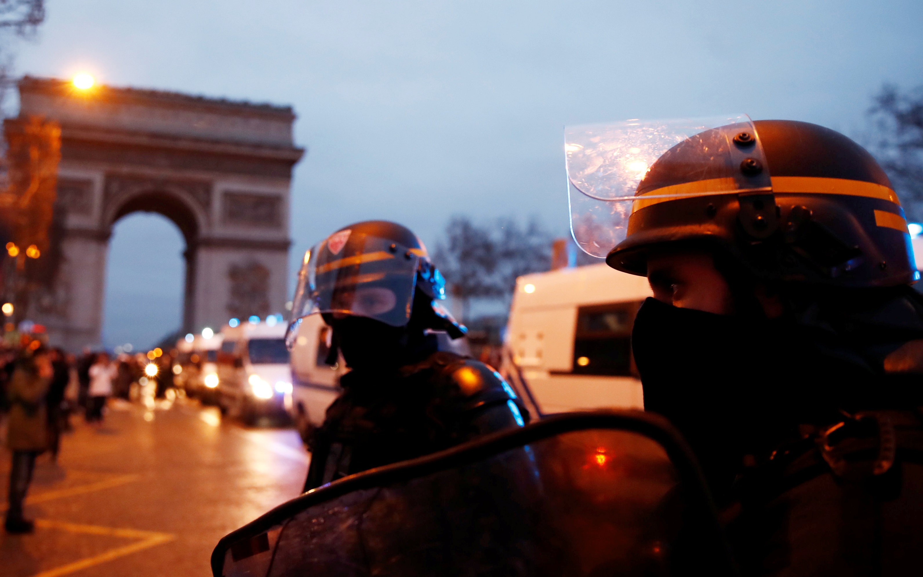 Riot police officers stand guard during a demonstration by the