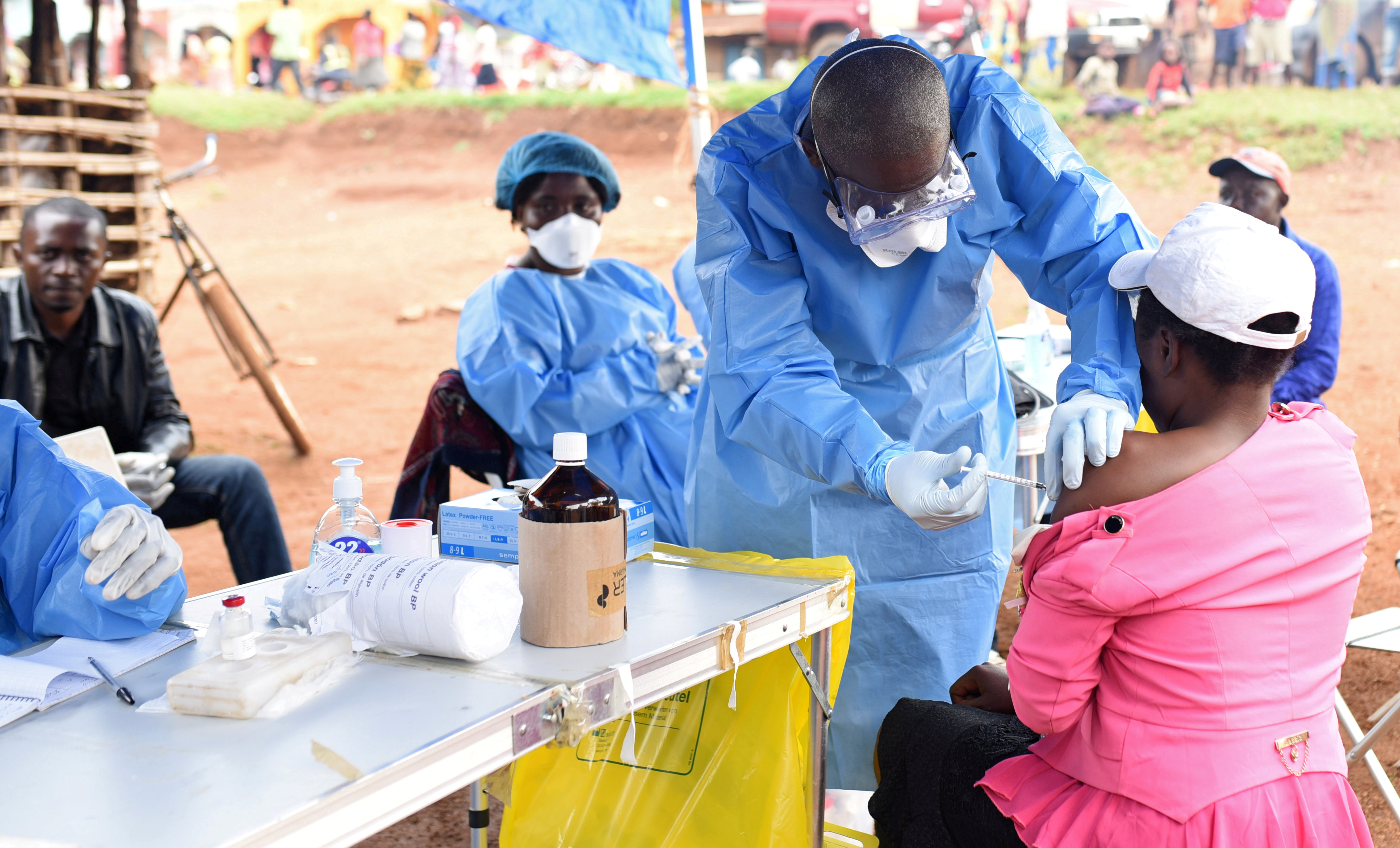 FILE PHOTO: A Congolese health worker administers Ebola vaccine to a woman who had contact with an Ebola sufferer in the village of Mangina