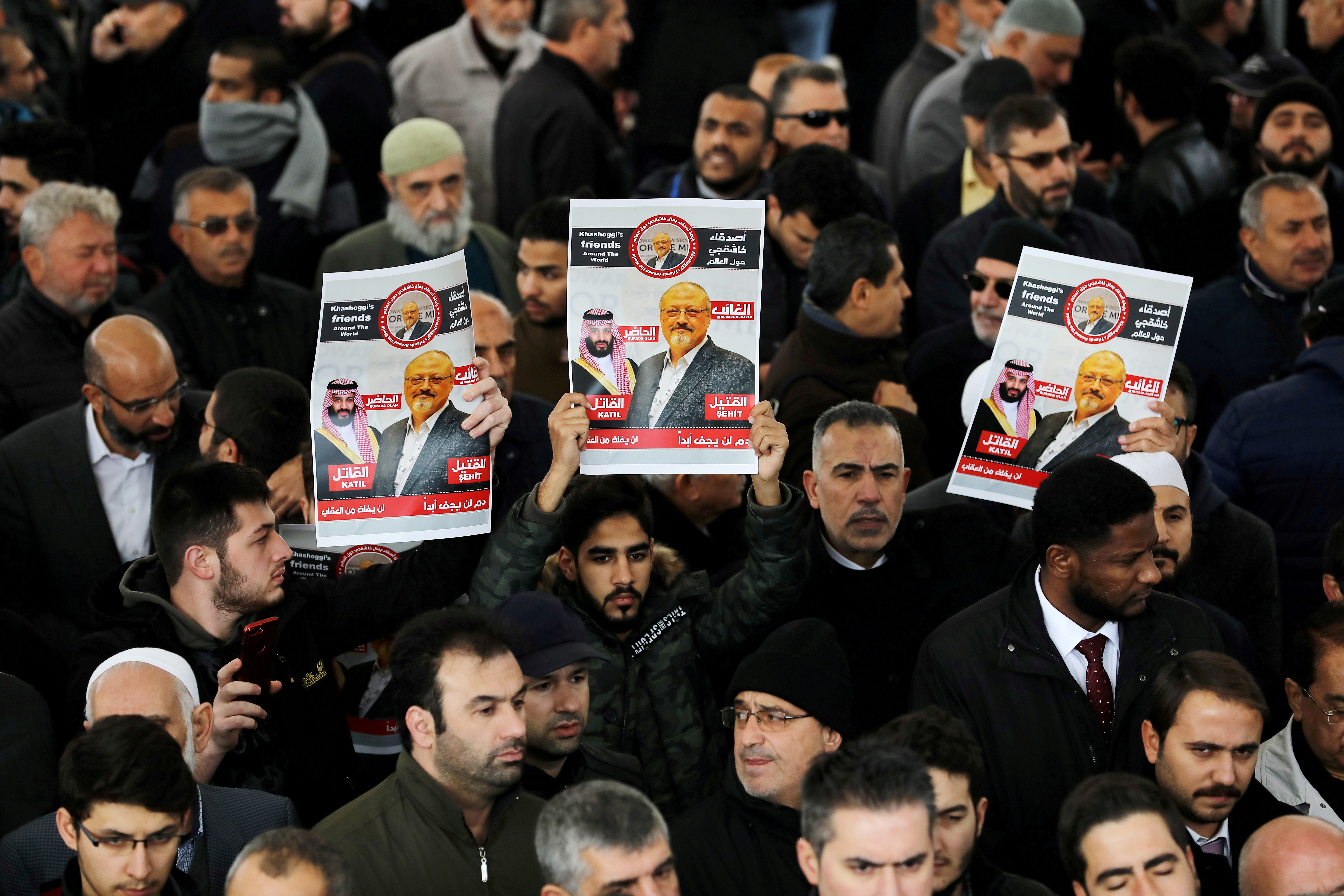 FILE PHOTO: People holding pictures of Saudi journalist Jamal Khashoggi attend a symbolic funeral prayer for Khashoggi at the courtyard of Fatih mosque in Istanbul