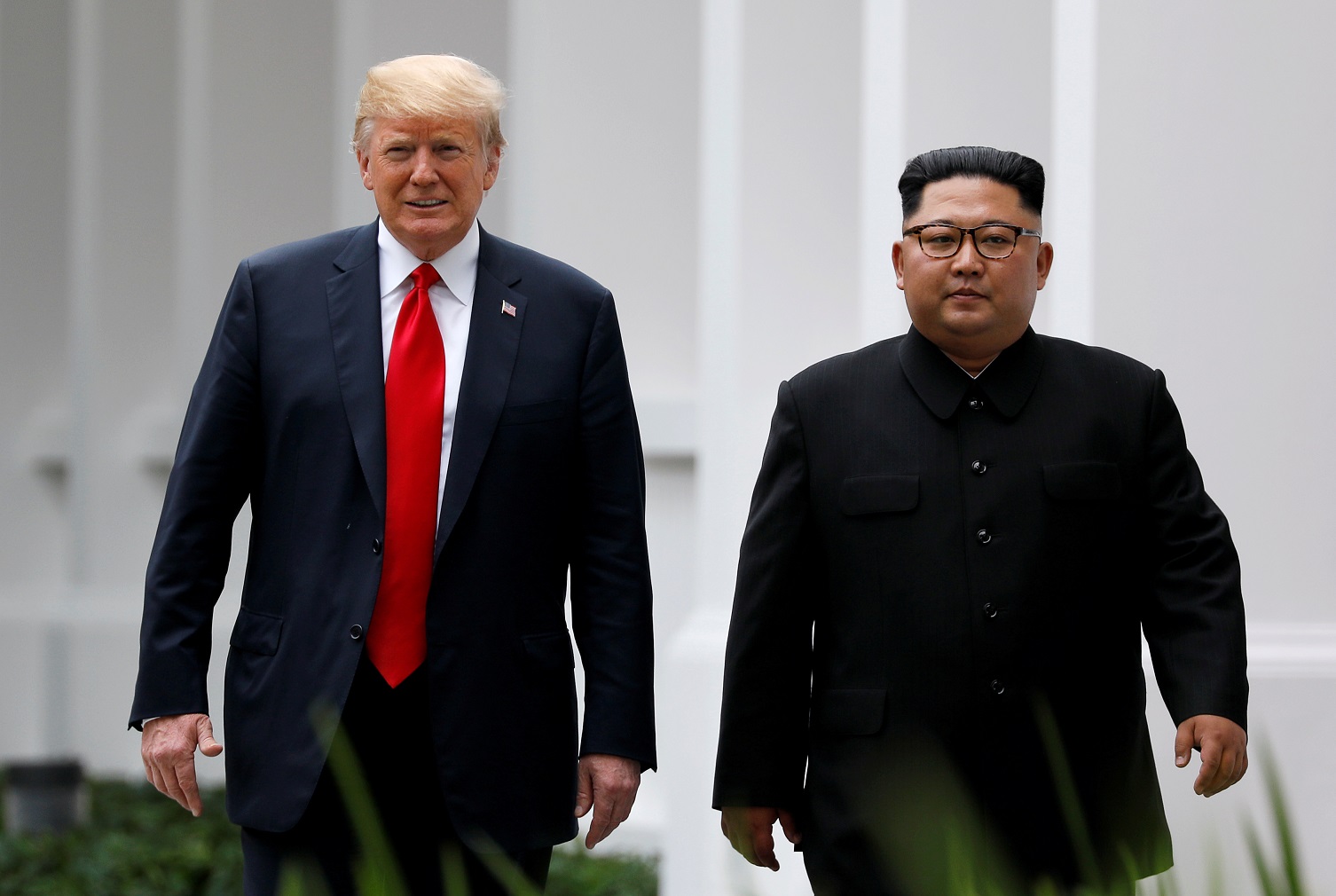 FILE PHOTO: U.S. President Donald Trump and North Korean leader Kim Jong Un walk after lunch at the Capella Hotel on Sentosa island in Singapore