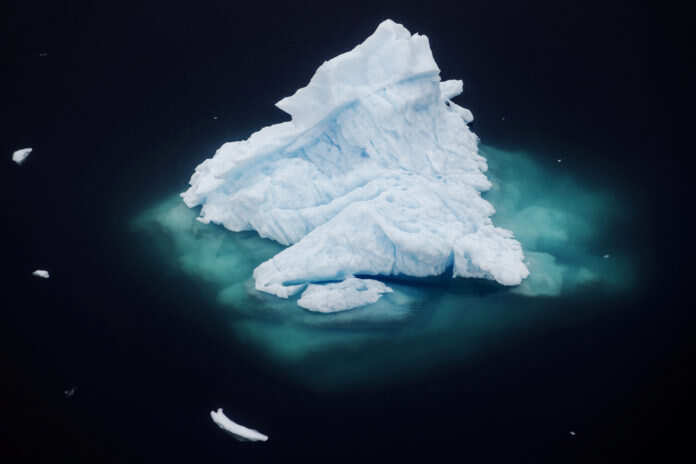 FILE PHOTO: Iceberg floats in a fjord near the town of Tasiilaq