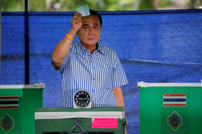 FILE PHOTO: Thai Prime Minister Prayuth Chan-ocha casts his ballot at a polling station during a constitutional referendum vote in Bangkok