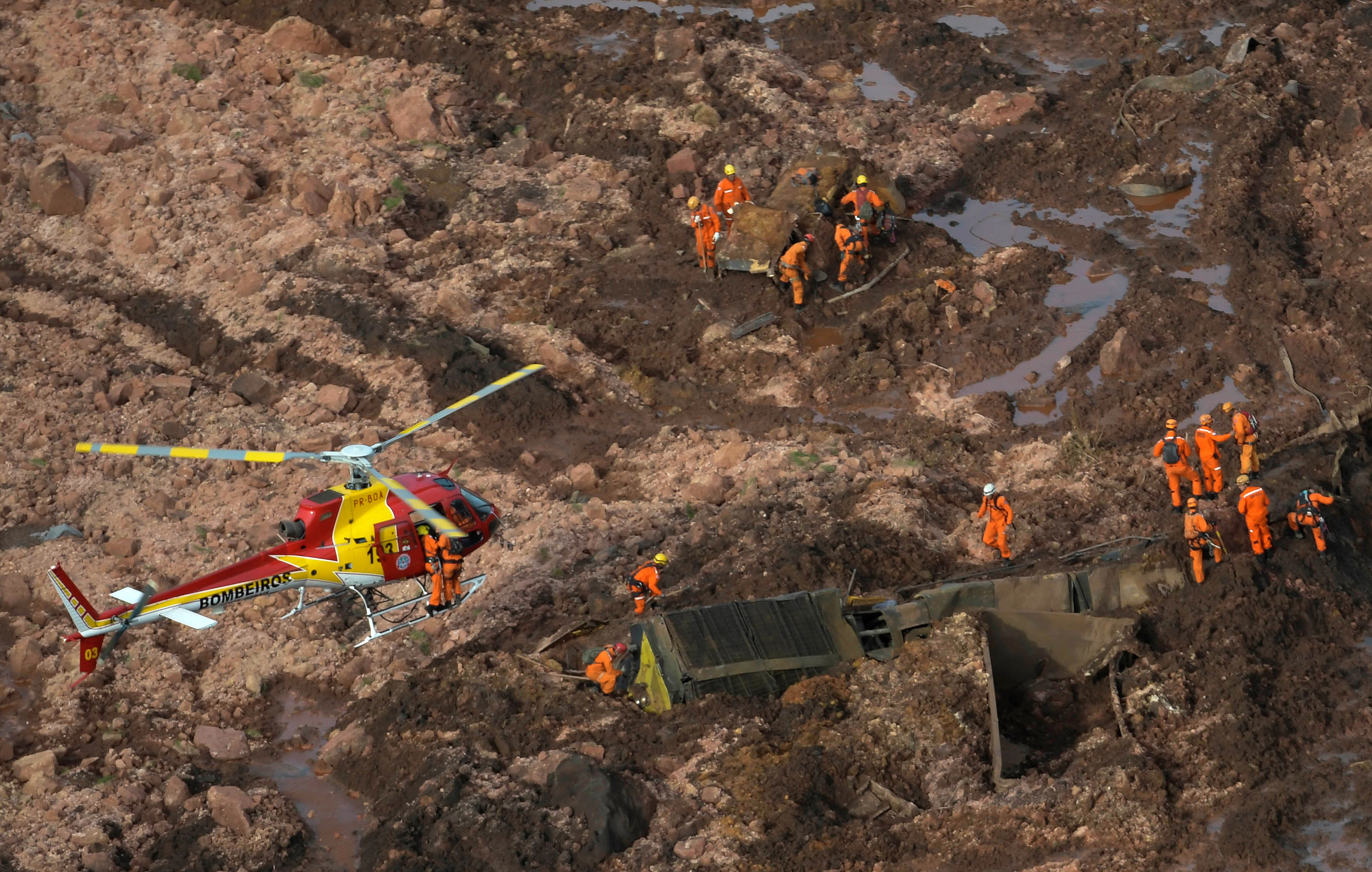 Rescue crew work in a tailings dam owned by Brazilian miner Vale SA that burst, in Brumadinho