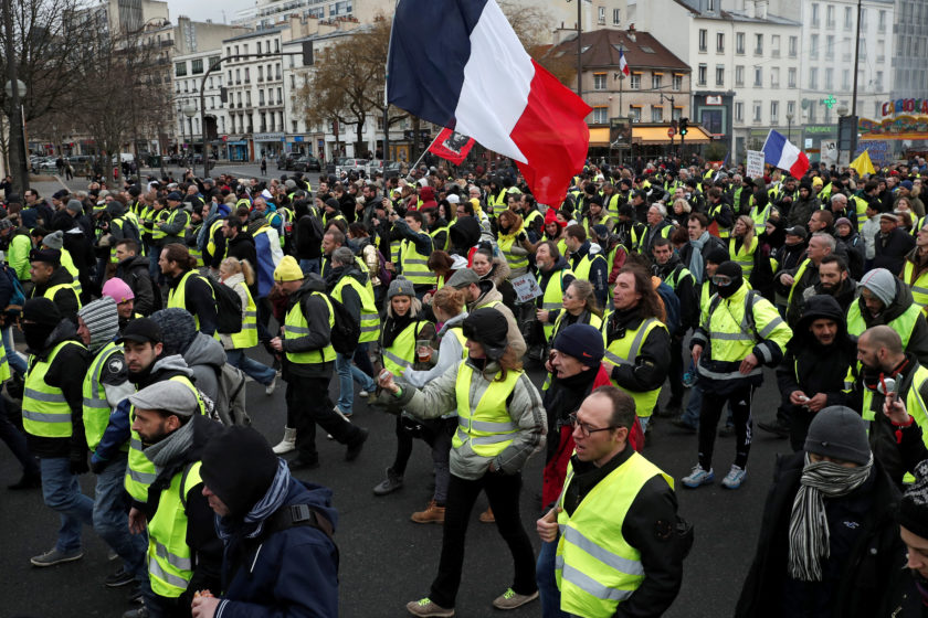 Protesters wearing yellow vests take part in a demonstration by the