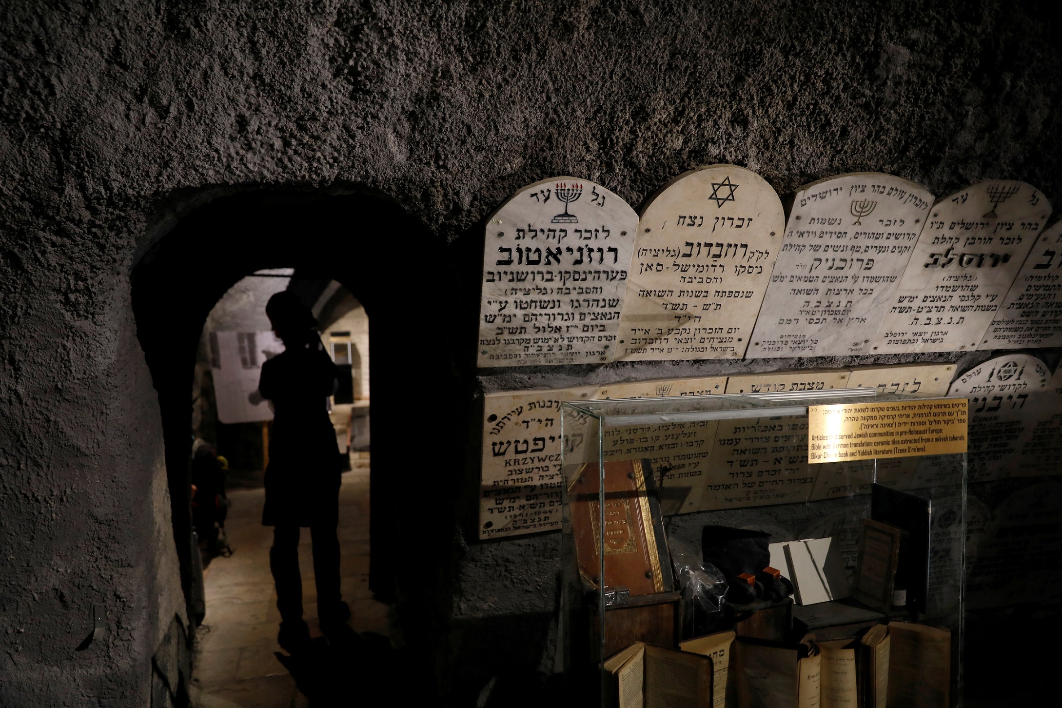 Gravestones commemorating the Jewish villages and towns whose communities were wiped out by the Nazis, are seen on a wall inside