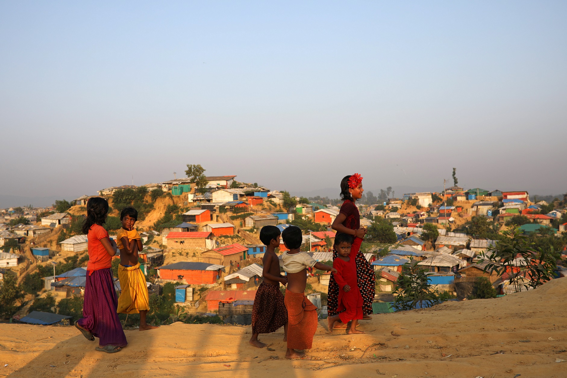 FILE PHOTO: Rohingya refugee children walk along the road at Balukhali camp in Cox’s Bazar