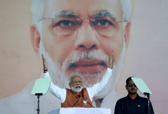 FILE PHOTO: India's Prime Minister Narendra Modi gestures as he addresses an election campaign rally in Meerut