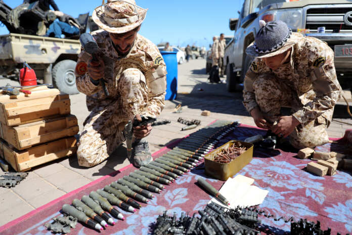 Members of Misrata forces, under the protection of Tripoli's forces, prepare themselves to go to the front line in Tripoli