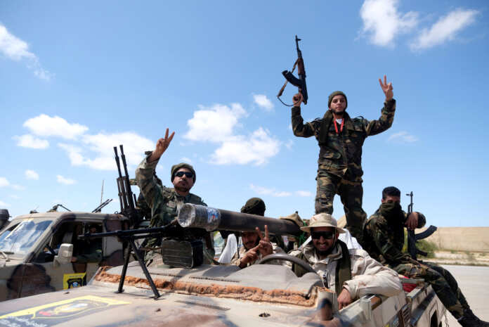 FILE PHOTO: Libyan National Army (LNA) members, commanded by Khalifa Haftar, head out of Benghazi to reinforce the troops advancing to Tripoli, in Benghazi