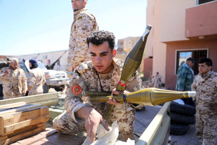 Members of Misrata forces, under the protection of Tripoli's forces, prepare themselves to go to the front line in Tripoli
