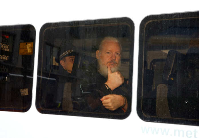 FILE PHOTO: WikiLeaks founder Julian Assange is seen in a police van after was arrested by British police outside the Ecuadorian embassy in London