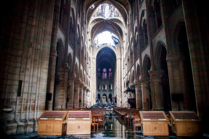 A view of the damaged roof and debris inside Notre-Dame de Paris in the aftermath of a fire that devastated the cathedral, during the visit of French Interior Minister Christophe Castaner, in Paris