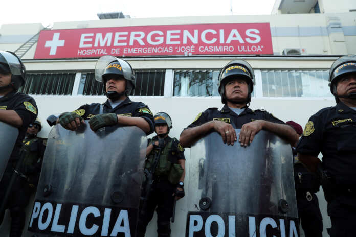 Police stand guard outside a hospital where Peru's former President Alan Garcia was taken after he shot himself, in Lima