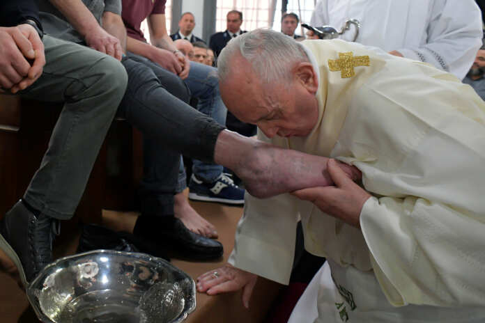Pope Francis kiss a foot of an inmate during the celebrations of the Holy Thursday at the District House of Velletri prison, in Velletri near Rome