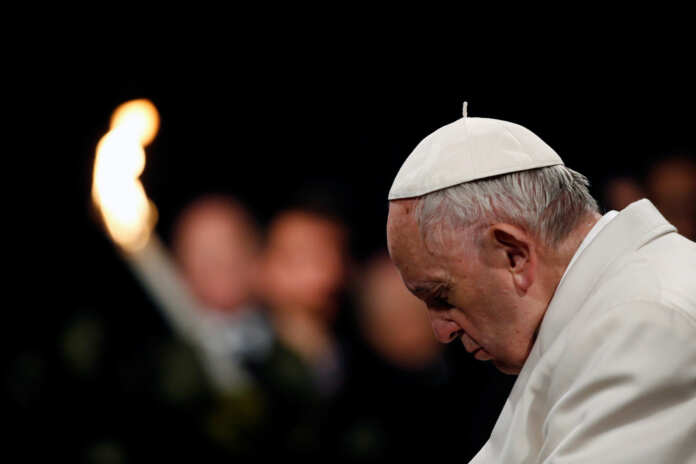 Pope Francis leads the Via Crucis (Way of the Cross) procession during Good Friday celebrations at the Colosseum in Rome