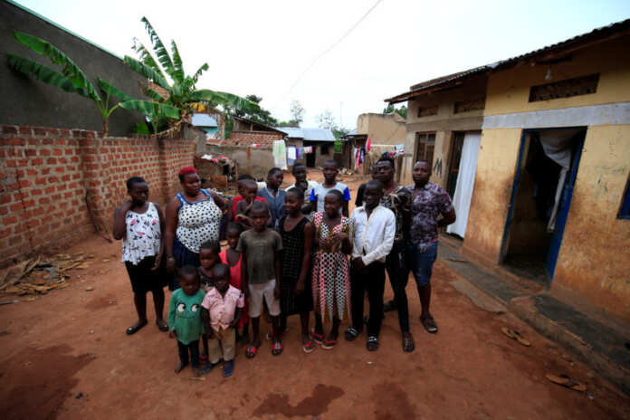Mariam Nabatanzi, a mother of 38, takes a family portrait with some of her children at their home in Kasawo village