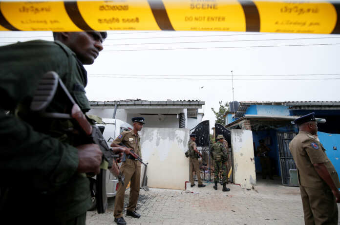 Security personnel at the site of an overnight gun battle, between troops and suspected Islamist militants, on the east coast of Sri Lanka, in Kalmunai