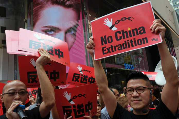 Demonstrators march during a protest to demand authorities scrap a proposed extradition bill with China, in Hong Kong