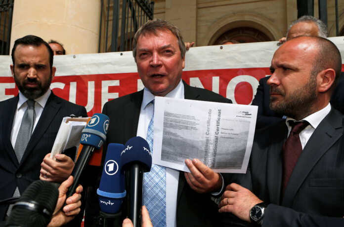 Claus-Peter Reisch, captain of the humanitarian charity ship MV Lifeline, speaks as he leaves the Courts of Justice accompanied by his lawyers after a court hearing in Valletta