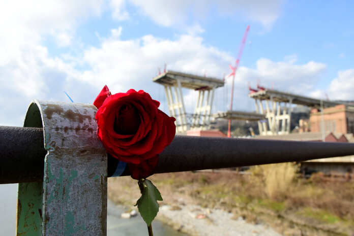 FILE PHOTO: Rose is placed on railings near the collapsed Morandi Bridge in Genoa