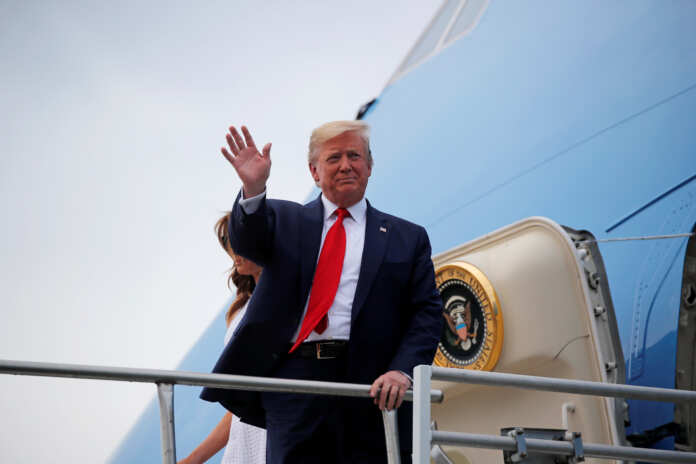 U.S. President Donald Trump reacts from the steps of Air Force One after arriving for a campaign rally in Orlando