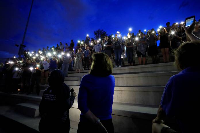 Mourners take part in a vigil at El Paso High School after a mass shooting at a Walmart store in El Paso