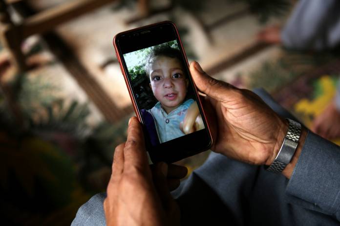 Mobile phone displaying picture of a boy who was killed after a cluster bomb that looked like a toy exploded in his hands at home in village Jabri, in Neelum Valley