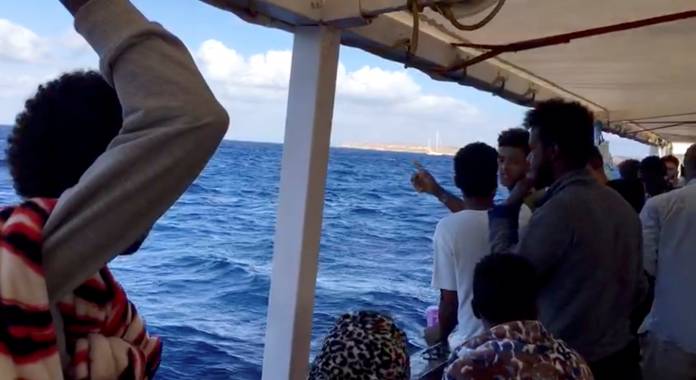 A still image taken from a video shows migrants on board the Spanish rescue ship Open Arms